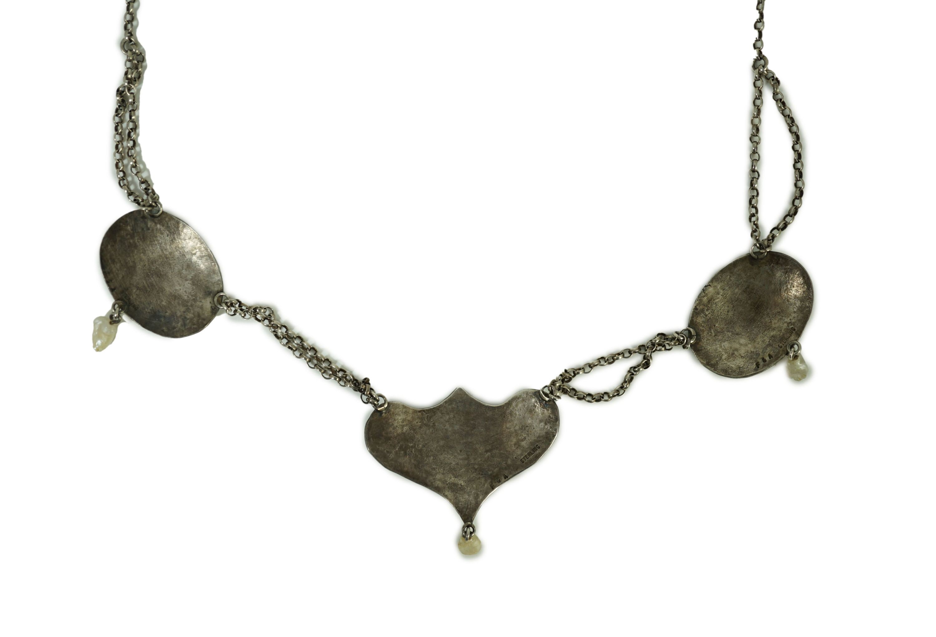 A stylish early 20th century sterling, enamel and baroque drop pearl set necklace